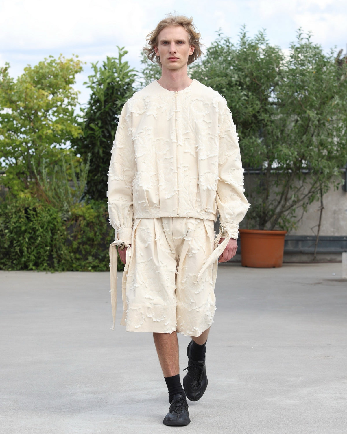 Pleated Shorts on the runway with the Pleated Bomber, ESCAPIST GARDEN SS27. Photograph: Boris Marberg for Berlin Fashion Week.